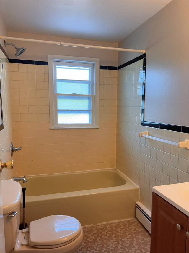 2333 Beech St, Wantagh, NY 11793 - bathroom with a baseboard heating unit, toilet, vanity, tub / shower combination, and tile walls