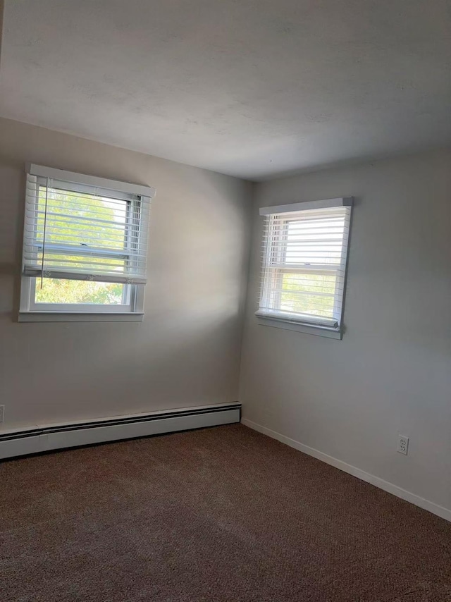 2333 Beech St, Wantagh, NY 11793 - carpeted spare room with plenty of natural light, a baseboard heating unit, and baseboards