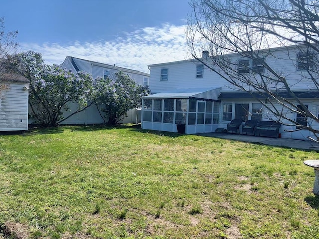 2333 Beech St, Wantagh, NY 11793 - back of house featuring a sunroom, a patio area, a lawn, and a chimney