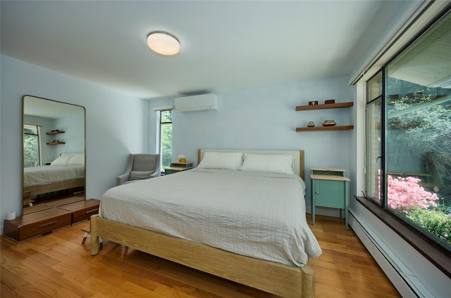 1 Ridge Rd, Tuxedo Park, NY 10987 - bedroom with baseboard heating, a wall mounted AC, and light wood-type flooring