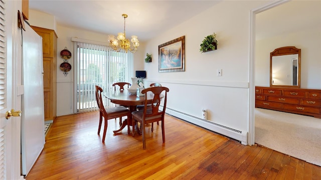 10 Lenox Ct Unit 806, Suffern, NY 10901 - dining room featuring a chandelier, baseboard heating, and light wood finished floors