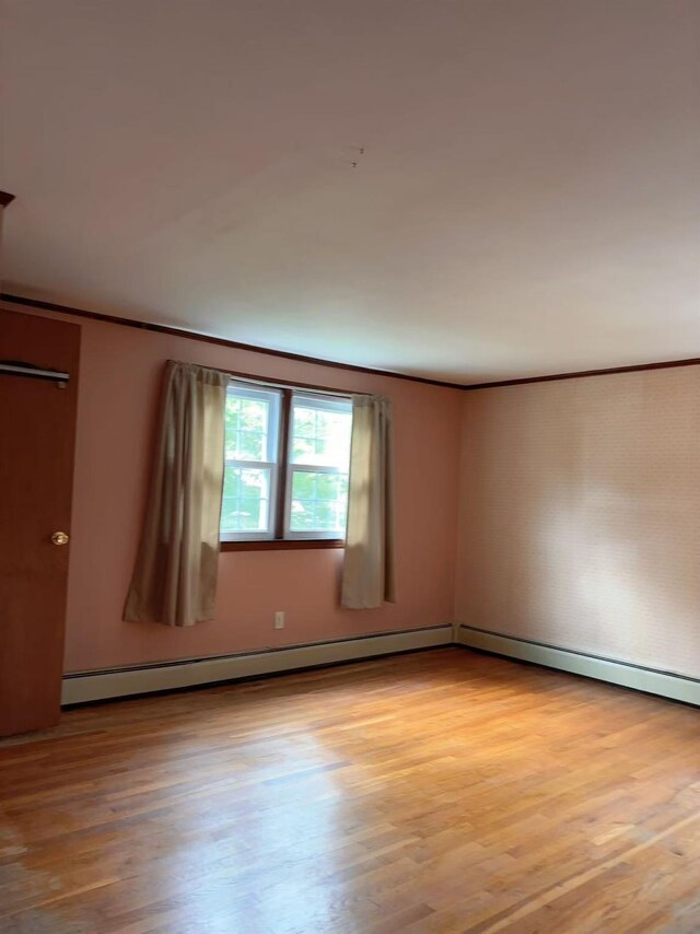 2090 Post St, East Meadow, NY 11554 - spare room featuring light wood-style floors and crown molding