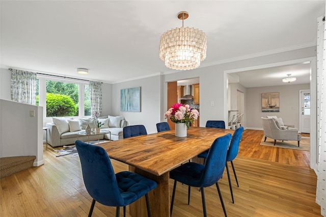 287 Harrison Ave, Harrison, NY 10528 - dining room with crown molding, healthy amount of natural light, light wood finished floors, and a chandelier