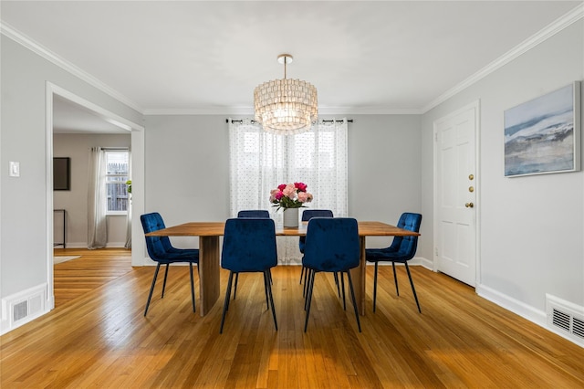 287 Harrison Ave, Harrison, NY 10528 - dining room with a chandelier, wood finished floors, and crown molding