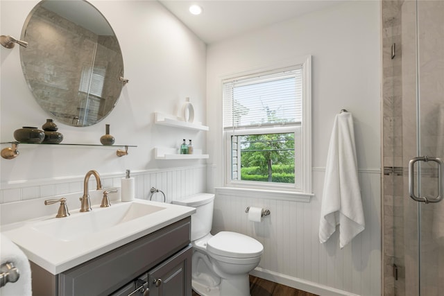 287 Harrison Ave, Harrison, NY 10528 - bathroom featuring a wainscoted wall, vanity, a stall shower, and wood finished floors