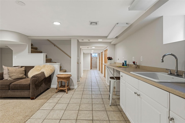 287 Harrison Ave, Harrison, NY 10528 - kitchen with white cabinetry, recessed lighting, open floor plan, light tile patterned floors, and light countertops