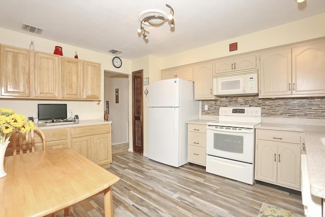 29 Park Ter, Valley Cottage, NY 10989 - kitchen featuring white appliances, light countertops, tasteful backsplash, and light wood-style flooring