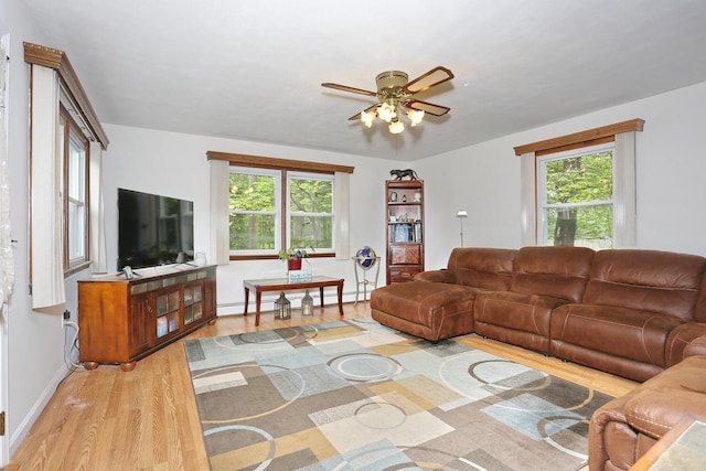 29 Park Ter, Valley Cottage, NY 10989 - living room with light wood finished floors, a ceiling fan, a baseboard heating unit, and baseboards