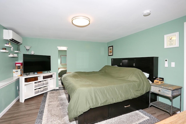 29 Park Ter, Valley Cottage, NY 10989 - bedroom with a wall unit AC, wood finished floors, and baseboards