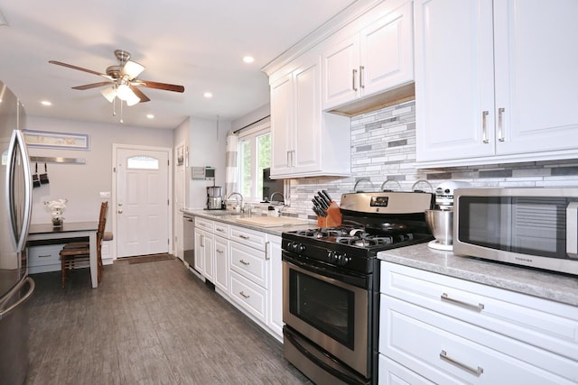 29 Park Ter, Valley Cottage, NY 10989 - kitchen with appliances with stainless steel finishes, a ceiling fan, backsplash, white cabinetry, and recessed lighting