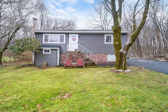25 Laura Rd, Monroe, NY 10950 - view of front of property with a chimney, brick siding, and a front yard