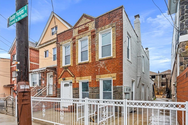107-30 156th St, Jamaica, NY 11433 - view of property with a fenced front yard, brick siding, and a gate