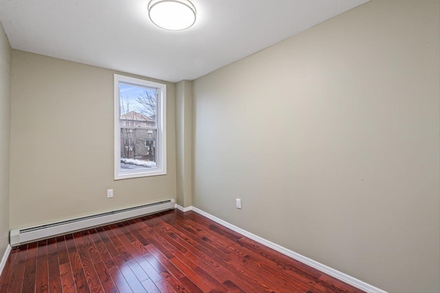 107-30 156th St, Jamaica, NY 11433 - empty room featuring a baseboard heating unit, baseboards, and dark wood-style flooring