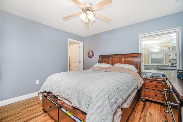 bedroom featuring light wood-type flooring, baseboards, and ceiling fan