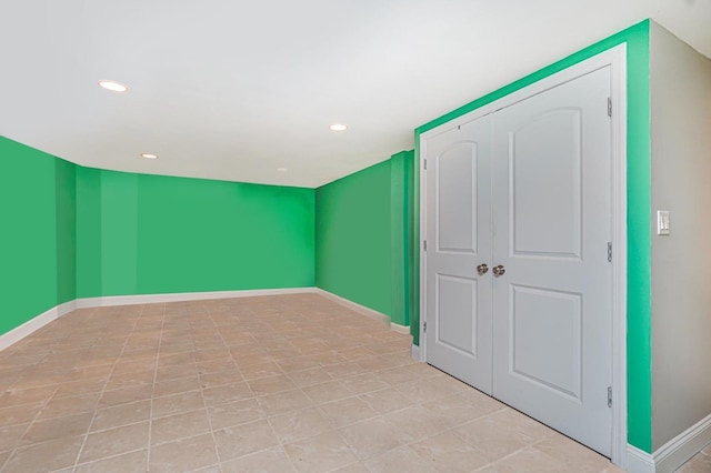additional living space with baseboards and recessed lighting