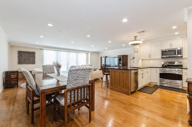 260 W Broadway Unit 2B, Long Beach, NY 11561 - dining room featuring crown molding, light wood-style floors, and recessed lighting