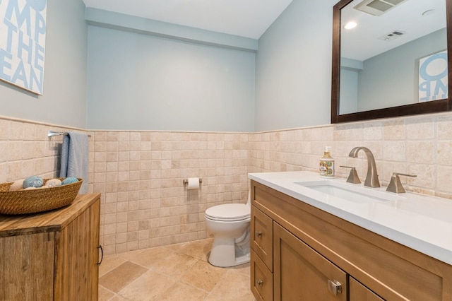 260 W Broadway Unit 2B, Long Beach, NY 11561 - bathroom with tile walls, toilet, vanity, and wainscoting