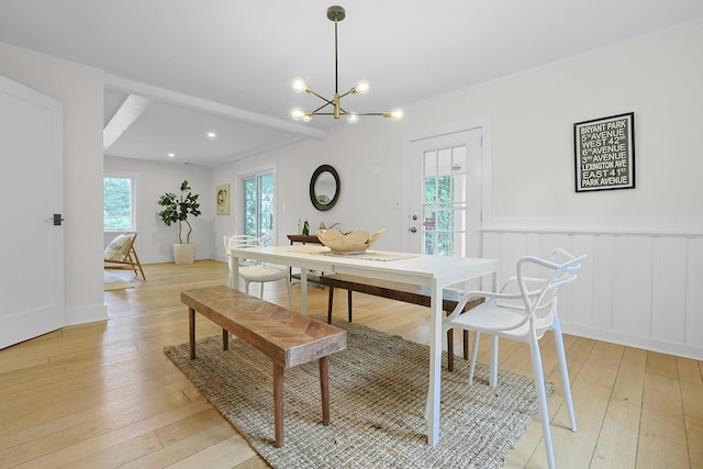 92 Glenwood Ave, New Rochelle, NY 10801 - dining space featuring a chandelier, light wood-type flooring, and a wainscoted wall