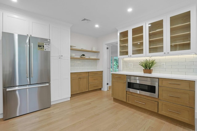 92 Glenwood Ave, New Rochelle, NY 10801 - kitchen with appliances with stainless steel finishes, tasteful backsplash, light wood-style flooring, light countertops, and recessed lighting