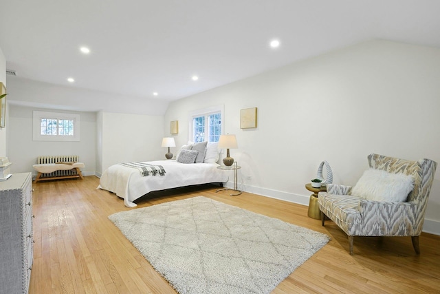 92 Glenwood Ave, New Rochelle, NY 10801 - bedroom with radiator heating unit, multiple windows, vaulted ceiling, light wood finished floors, and recessed lighting