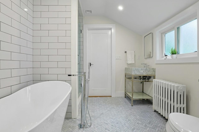 92 Glenwood Ave, New Rochelle, NY 10801 - full bathroom with radiator, a freestanding bath, vaulted ceiling, recessed lighting, and vanity