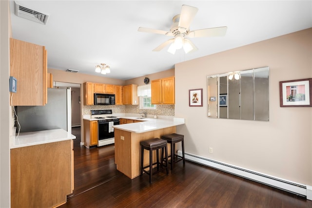 84 Autumn Dr, Poughkeepsie, NY 12603 - kitchen featuring range with gas cooktop, black microwave, a baseboard radiator, a breakfast bar, and a peninsula