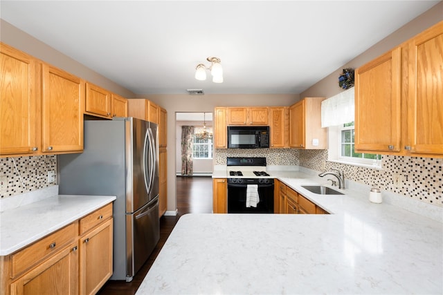 84 Autumn Dr, Poughkeepsie, NY 12603 - kitchen with black microwave, range with gas stovetop, a sink, and plenty of natural light