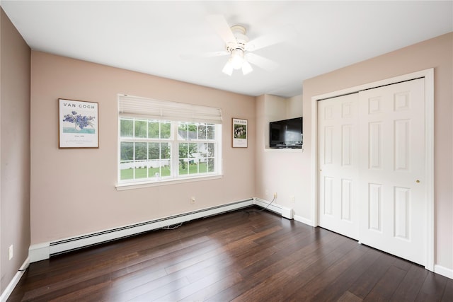 84 Autumn Dr, Poughkeepsie, NY 12603 - unfurnished bedroom with baseboard heating, dark wood-style flooring, a closet, and baseboards