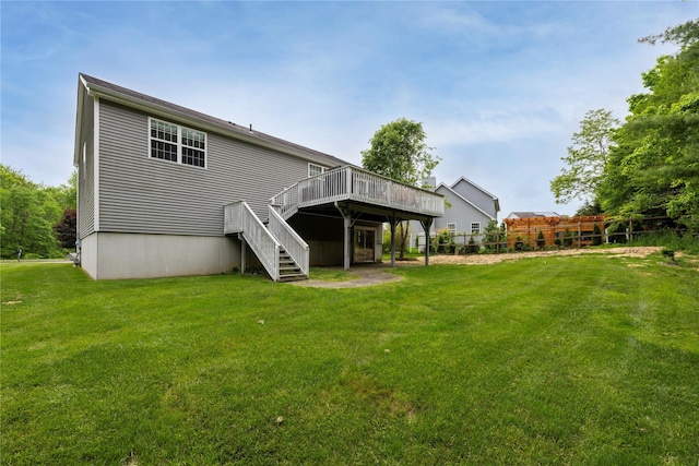 84 Autumn Dr, Poughkeepsie, NY 12603 - back of house featuring stairway, a wooden deck, and a lawn