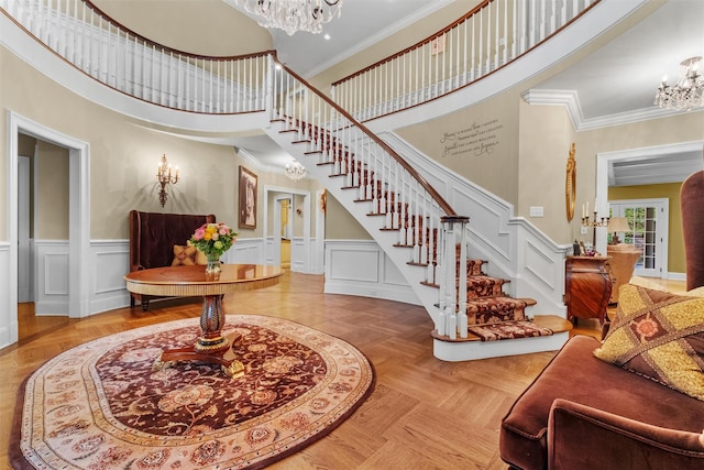 7 Ridgeview Cir, Armonk, NY 10504 - entrance foyer featuring a chandelier, stairway, a towering ceiling, crown molding, and a wainscoted wall
