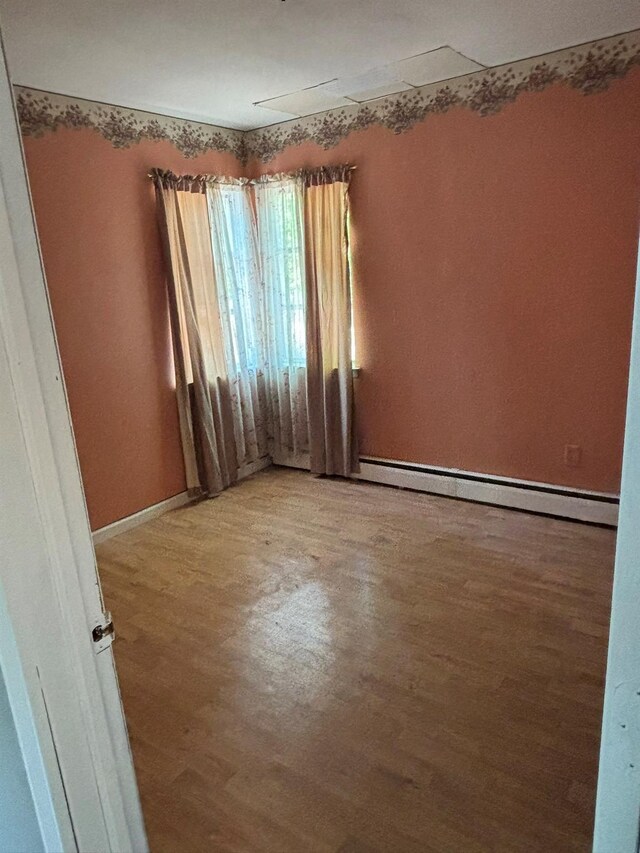 212 Longfellow Dr, Mastic Beach, NY 11951 - unfurnished room featuring light wood finished floors and a baseboard heating unit