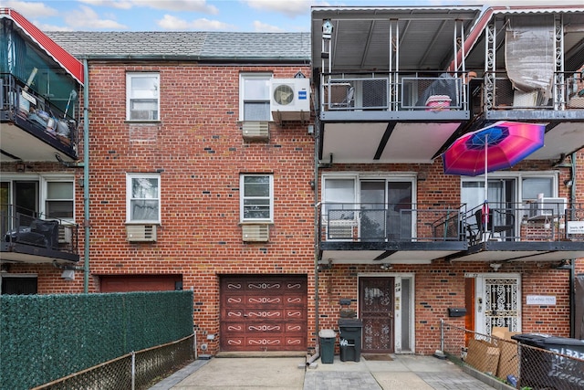 71-34 Kissena Blvd, Flushing, NY 11367 - view of property featuring a garage, concrete driveway, and cooling unit
