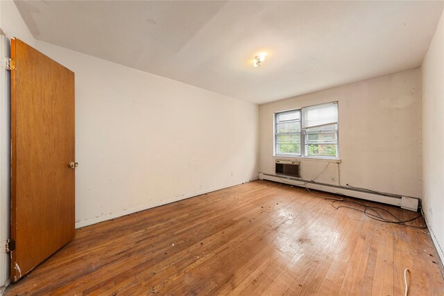 71-34 Kissena Blvd, Flushing, NY 11367 - empty room with a baseboard heating unit and wood-type flooring