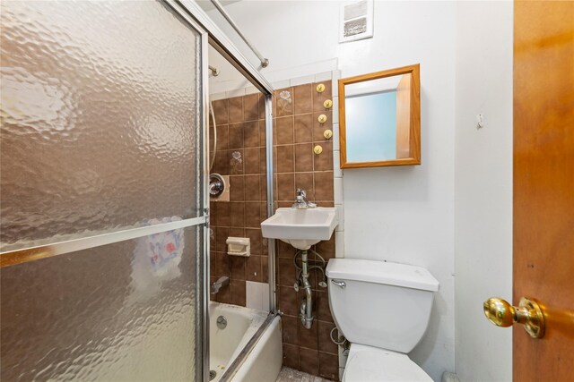 71-34 Kissena Blvd, Flushing, NY 11367 - bathroom featuring toilet, a sink, and shower / bath combination with glass door