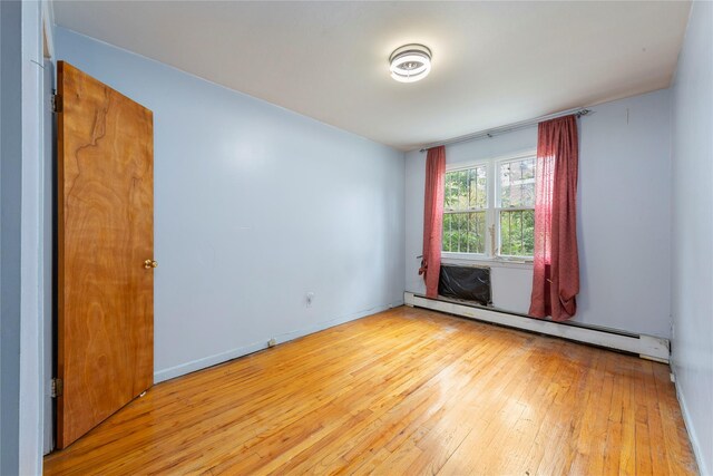 71-34 Kissena Blvd, Flushing, NY 11367 - unfurnished room featuring baseboard heating and hardwood / wood-style floors