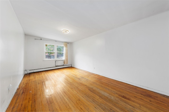 71-34 Kissena Blvd, Flushing, NY 11367 - empty room with baseboard heating and hardwood / wood-style floors