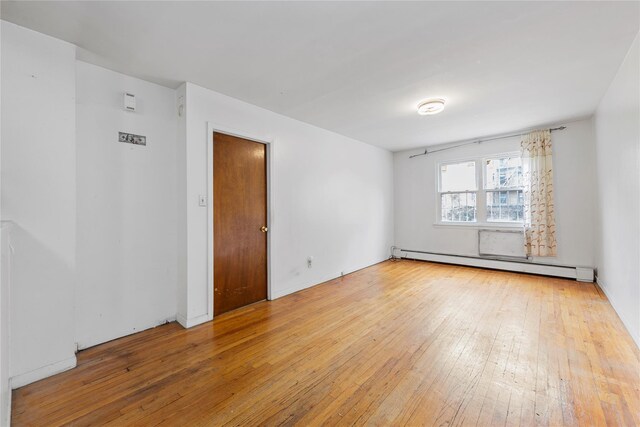 71-34 Kissena Blvd, Flushing, NY 11367 - spare room with baseboard heating and hardwood / wood-style flooring