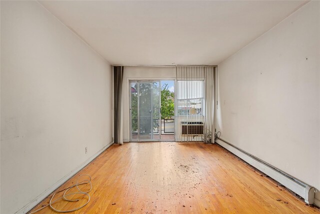 71-34 Kissena Blvd, Flushing, NY 11367 - empty room with baseboard heating and wood finished floors