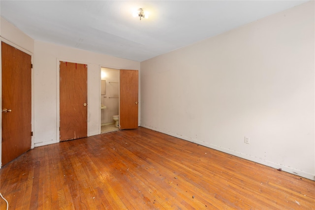 71-34 Kissena Blvd, Flushing, NY 11367 - unfurnished bedroom featuring hardwood / wood-style floors and connected bathroom