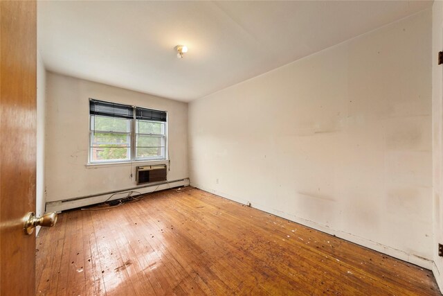 71-34 Kissena Blvd, Flushing, NY 11367 - spare room with baseboard heating, light wood-type flooring, and a wall mounted AC