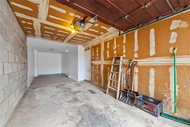 71-34 Kissena Blvd, Flushing, NY 11367 - miscellaneous room featuring concrete block wall, concrete flooring, and a garage