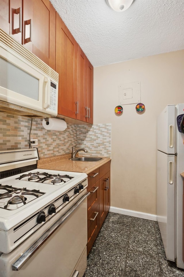39-60 54th St Unit 3B, Woodside, NY 11377 - kitchen featuring white appliances, a sink, backsplash, baseboards, and brown cabinetry