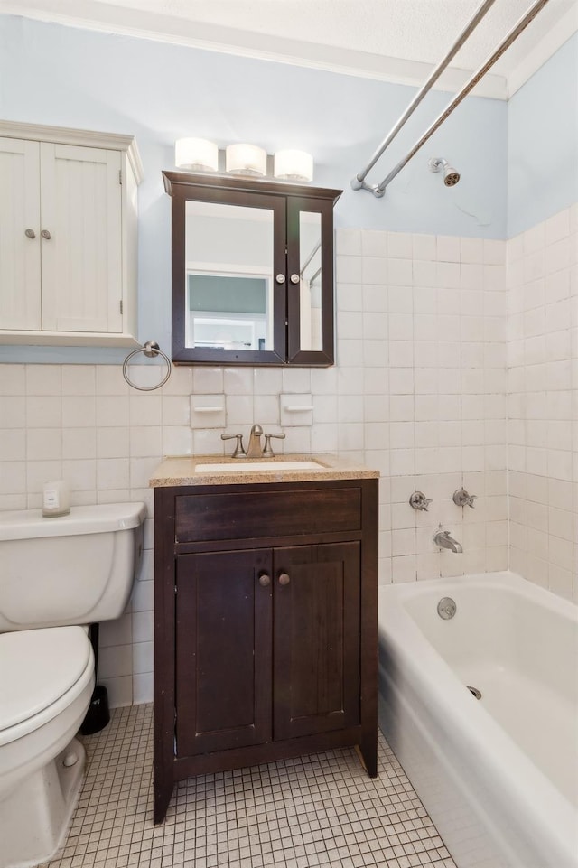 39-60 54th St Unit 3B, Woodside, NY 11377 - bathroom with tile walls, toilet, tile patterned floors, vanity, and bathtub / shower combination