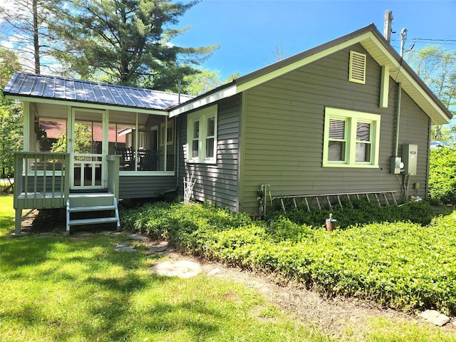 45 W Kenoza Pl, Smallwood, NY 12778 - back of house featuring a yard, metal roof, and a sunroom