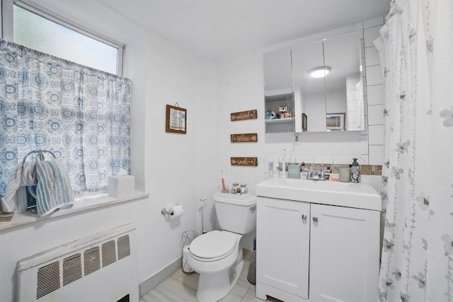 135 Highland Ave S Unit D1, Ossining, NY 10562 - full bath with radiator heating unit, vanity, toilet, and tile patterned flooring