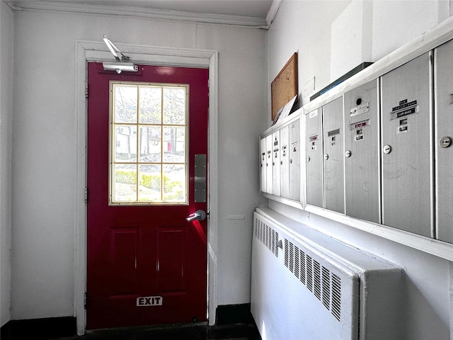 doorway to outside with crown molding