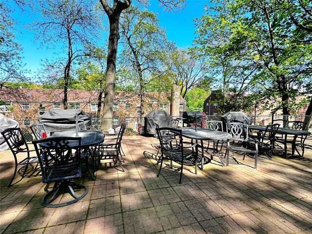 view of patio / terrace with outdoor dining space, fence, and area for grilling