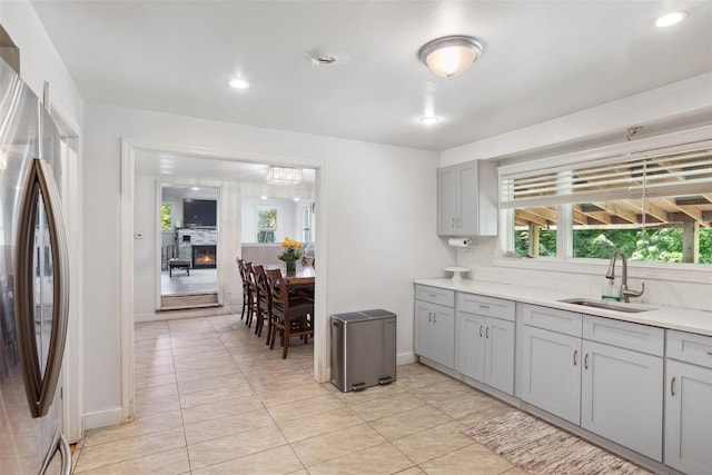 21 Wagon Ln, Brewster, NY 10509 - kitchen with a sink, freestanding refrigerator, gray cabinets, light countertops, and decorative backsplash