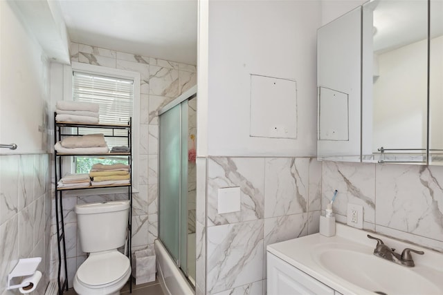 21 Wagon Ln, Brewster, NY 10509 - bathroom featuring tile walls, toilet, vanity, and enclosed tub / shower combo