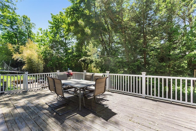 21 Wagon Ln, Brewster, NY 10509 - deck with a trampoline, outdoor dining area, and view of wooded area